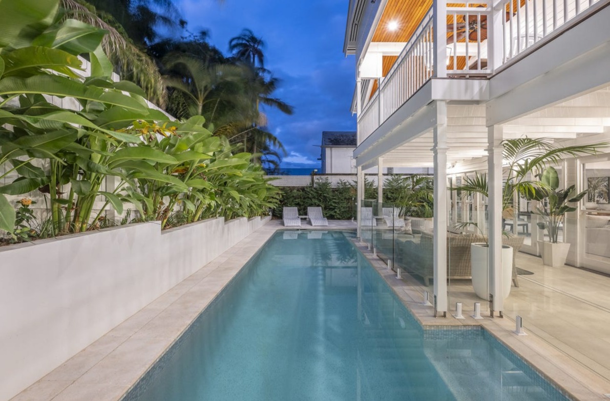 Lap pool alongside Queenslander verandah at twilight