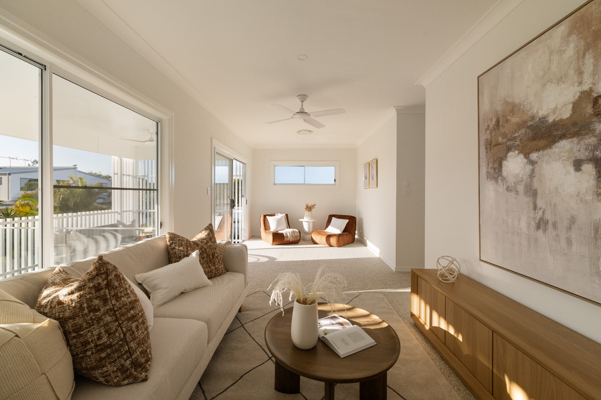 Sunlit living room with neutral palette and timber details