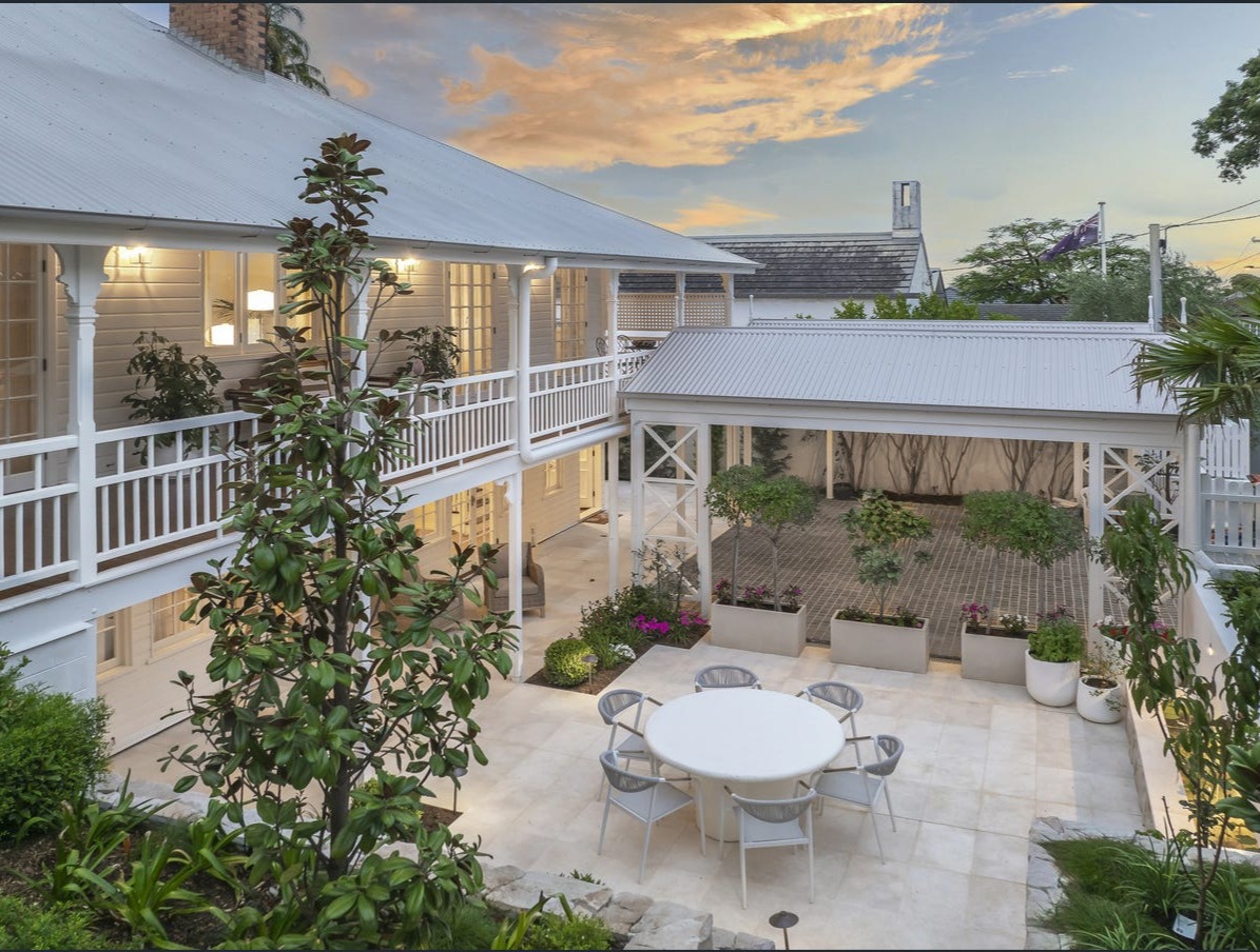 Restored Queenslander with breezeway courtyard at dusk